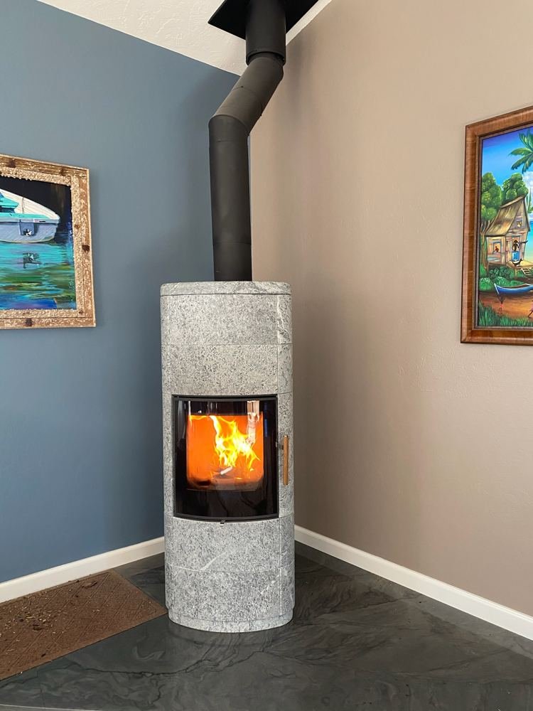 Soapstone wood stove with fire burning